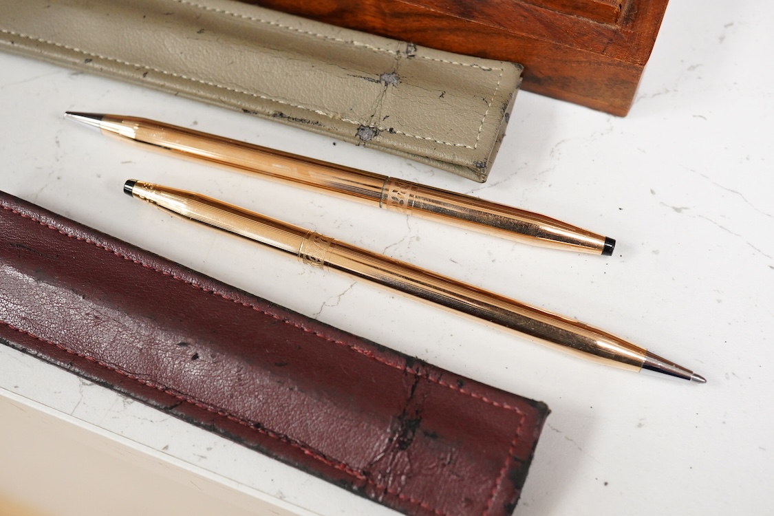 A group of five fountain pens and ballpoint pens